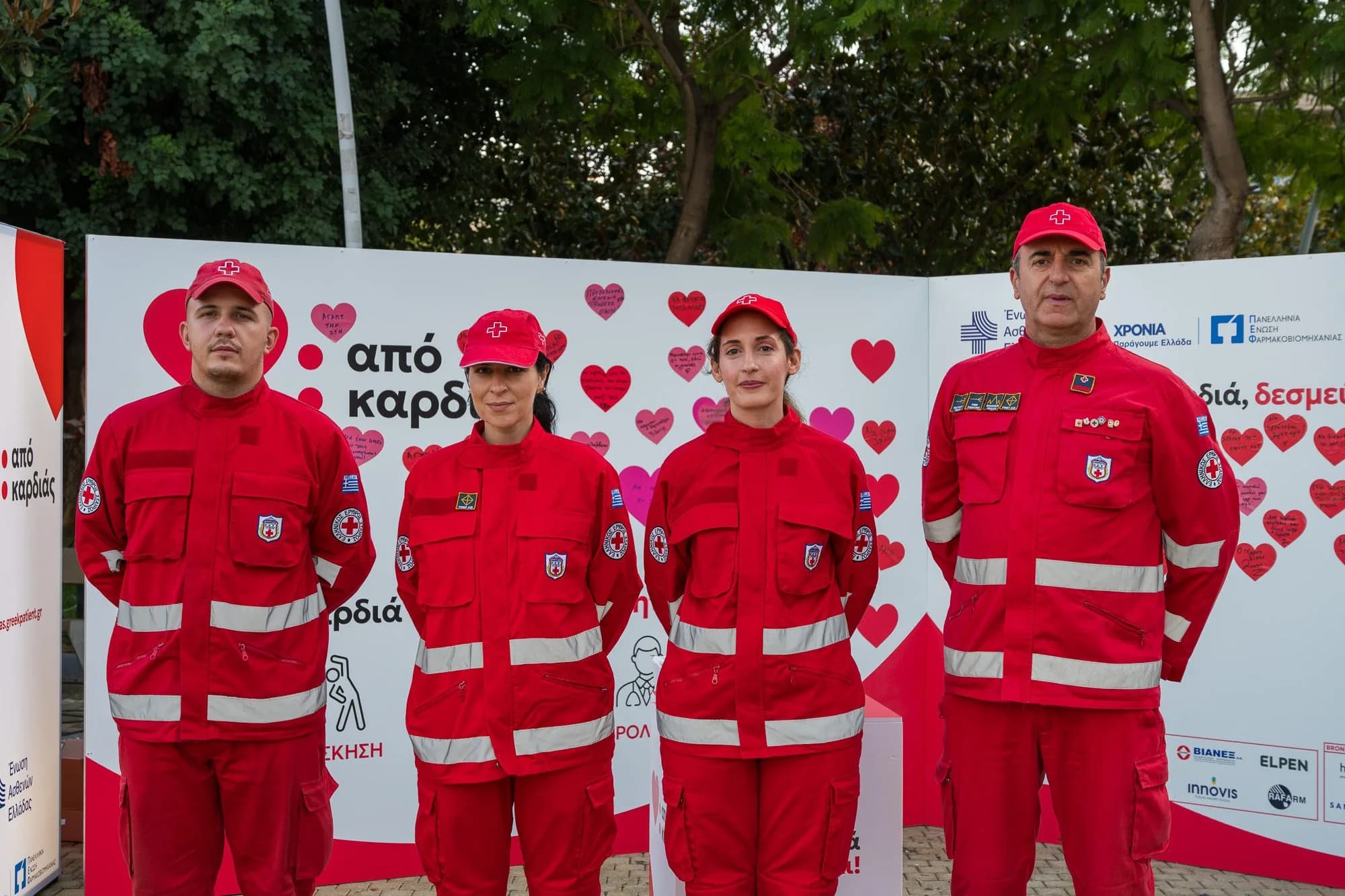 Εθελοντές του Ελληνικού Ερυθρού Σταυρού μπροστά στον τοίχο της εκστρατείας.